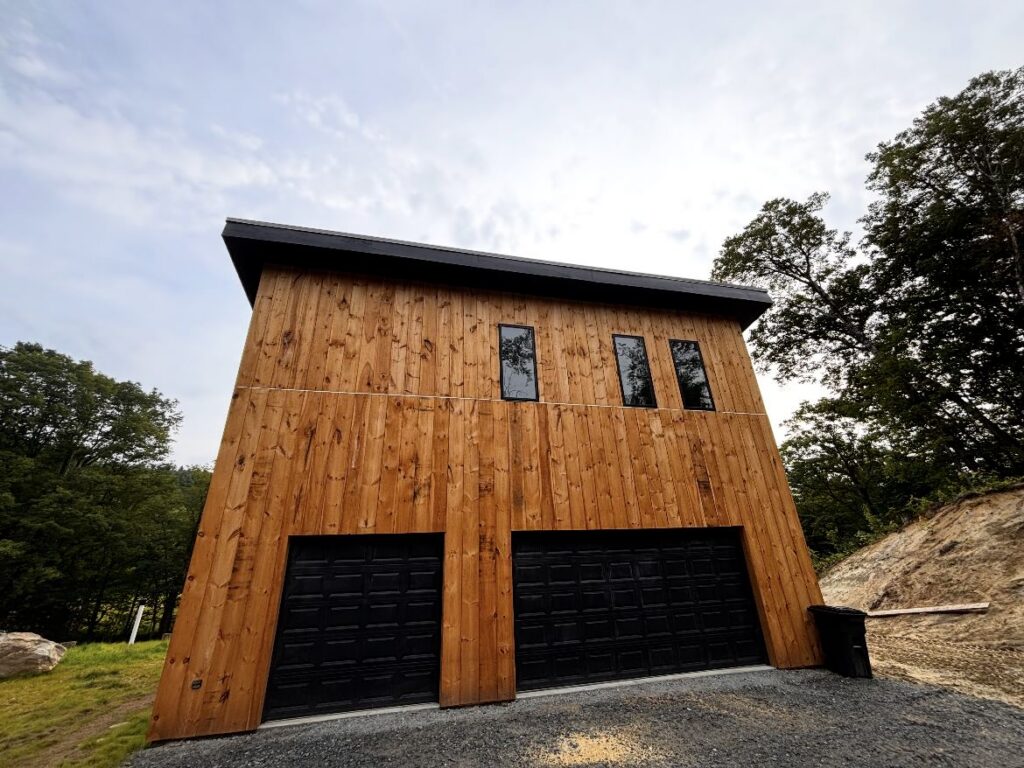 New cedar-sided garage with two bays